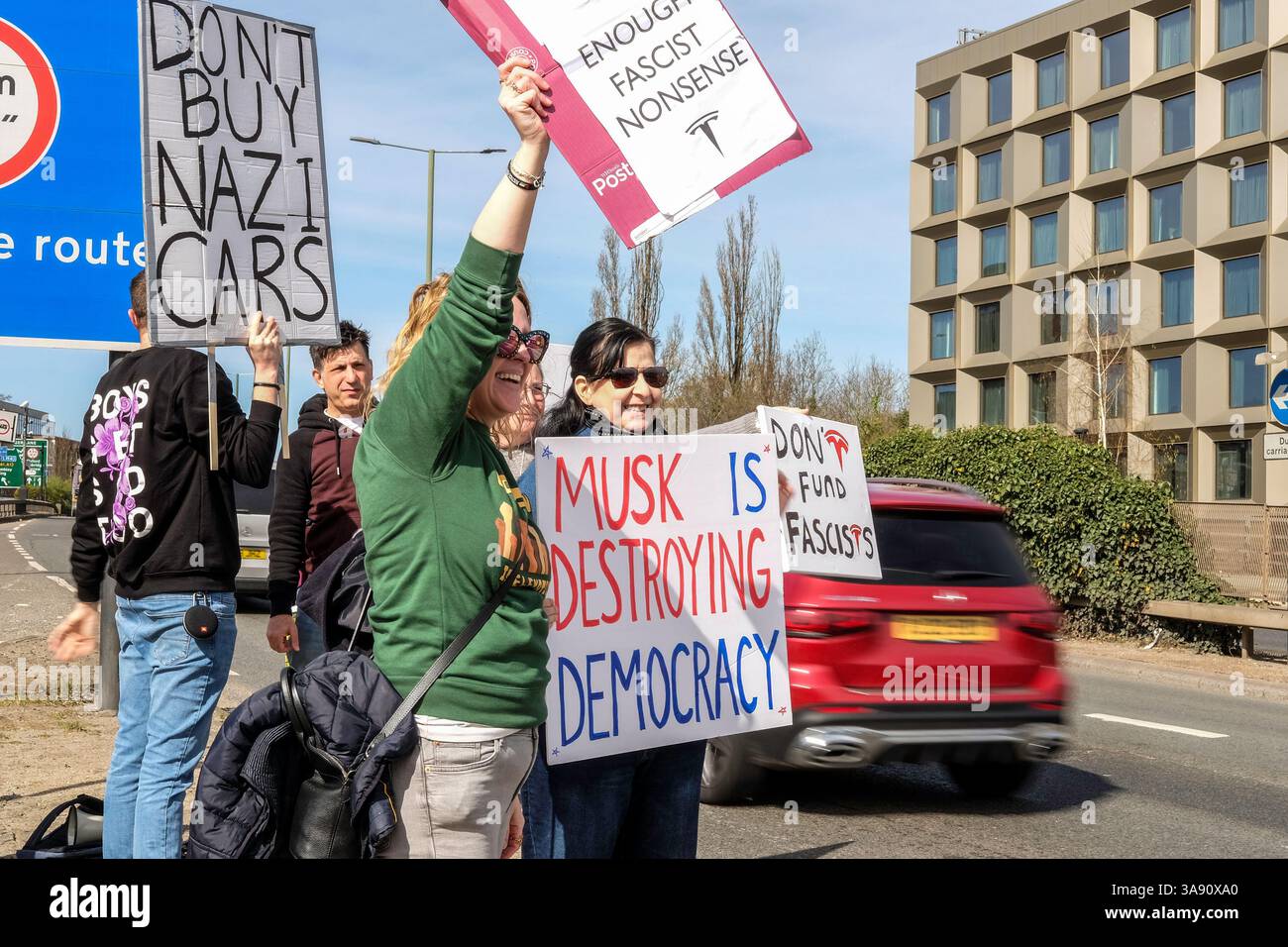 März 2025, London, Großbritannien. Demonstranten gegen Elon Musk und seine politischen Aktionen bei der US-Kundgebung vor dem Tesla Car Showroom im Park Royal, London. Der Londoner Protest ist Teil eines globalen Aktionstages unter dem Dach der Tesla Takedown-Bewegung. Die Organisatoren sagen, dass die Kundgebungen vor mehr als 200 Tesla-Standorten weltweit stattfinden werden. Die Demonstranten ermutigen die Autofahrer, beim Besuch des Tesla Showrooms in London die Hupe zu läuten. Stockfoto