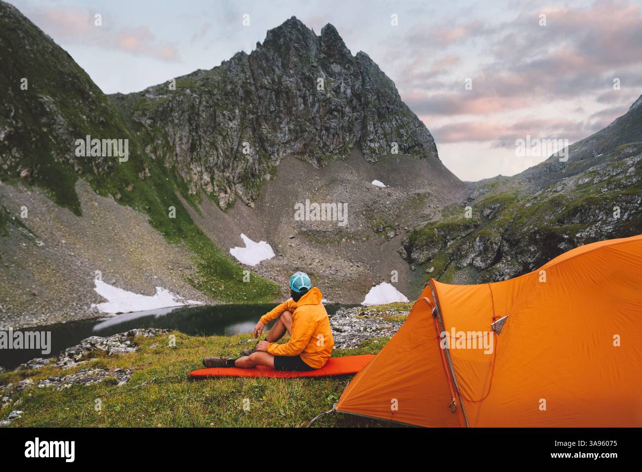 Mann Wandern allein mit Campingausrüstung Zelt Tourist sitzend auf Schlaffläche - Reise Abenteuer gesunder Lebensstil Sommer aktive Ferien Trekking Tour Surv Stockfoto