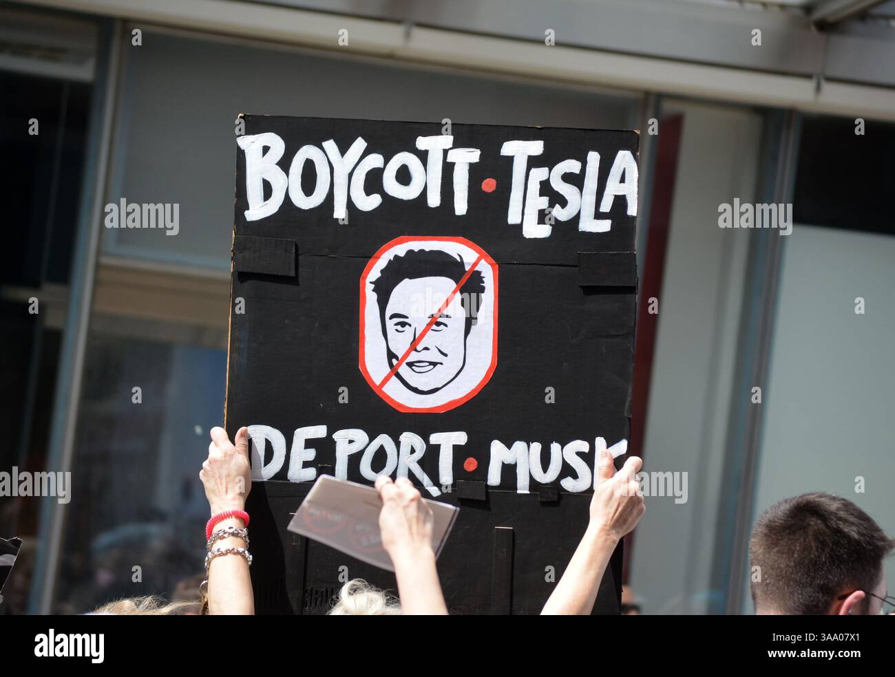 Tesla Takedown Demonstration gegen Elon Musk und DOGE, die zu einem Tesla Showroom in Manhattan marschieren. Stockfoto