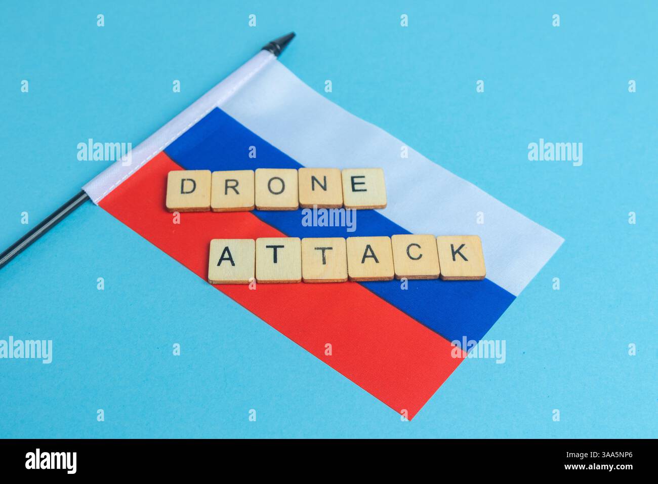 Die Nationalflagge der Russischen Föderation, zusammen mit einem Schild mit Drohnenangriff Stockfoto