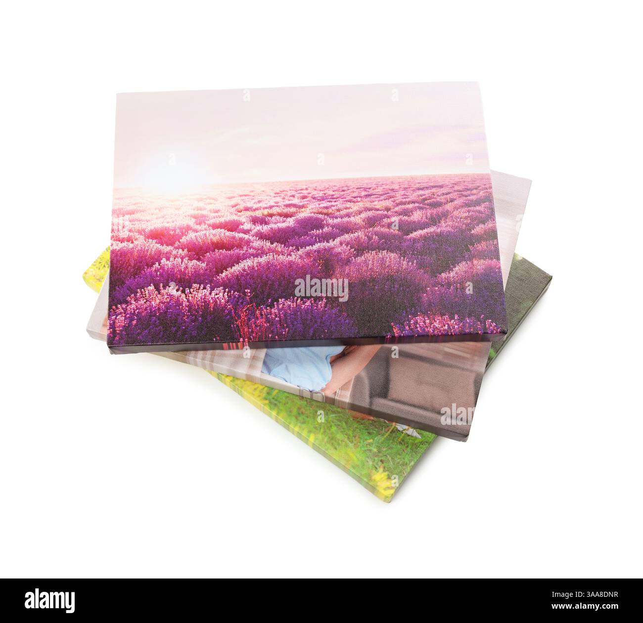 Leinwand mit verschiedenen gedruckten Fotos, isoliert auf weiß, über der Ansicht Stockfoto