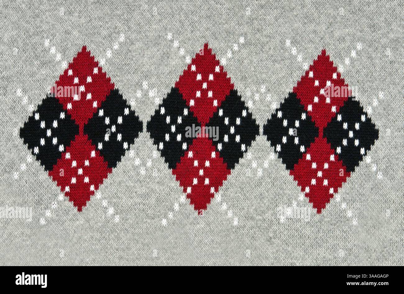 Gestrickter grauer Hintergrund mit einem Muster Stockfoto