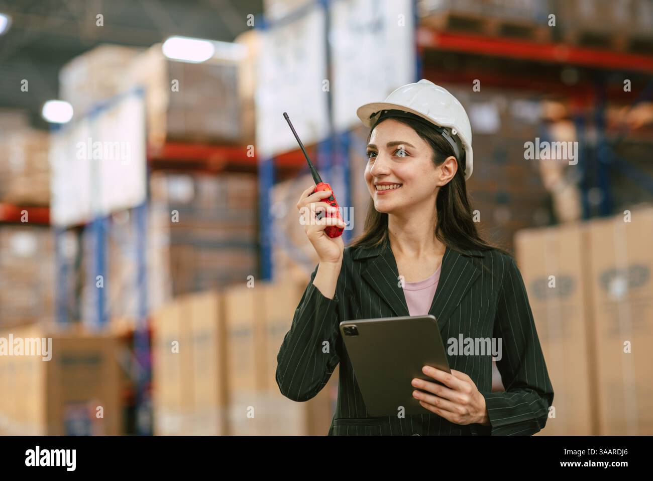 Geschäftsfrauen, die im Frachtlager arbeiten, verwalten den Lagerbestand von Betriebskontrollprodukten per Funk Stockfoto