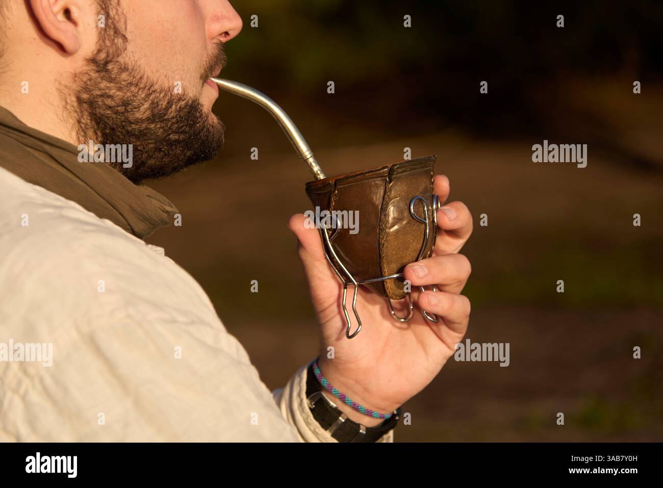 Nicht wiedererkennbare bärtige argentinische Getränke paaren sich früh am Morgen draußen. Nahansicht. Stockfoto