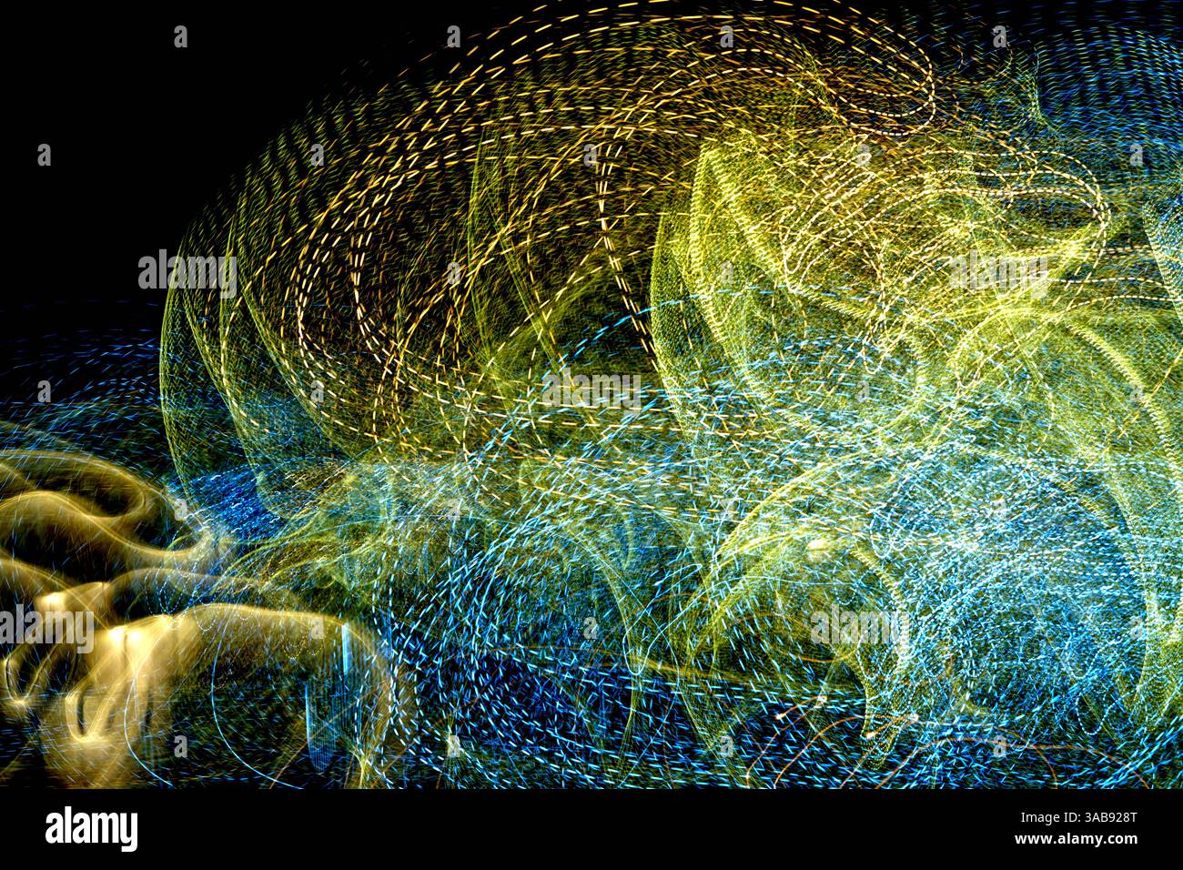 Lebendige Lichtspuren wirbeln und tanzen über die dunkle Kulisse und schaffen eine fesselnde abstrakte Darstellung von Bewegung und Energie, die den fesseln Stockfoto