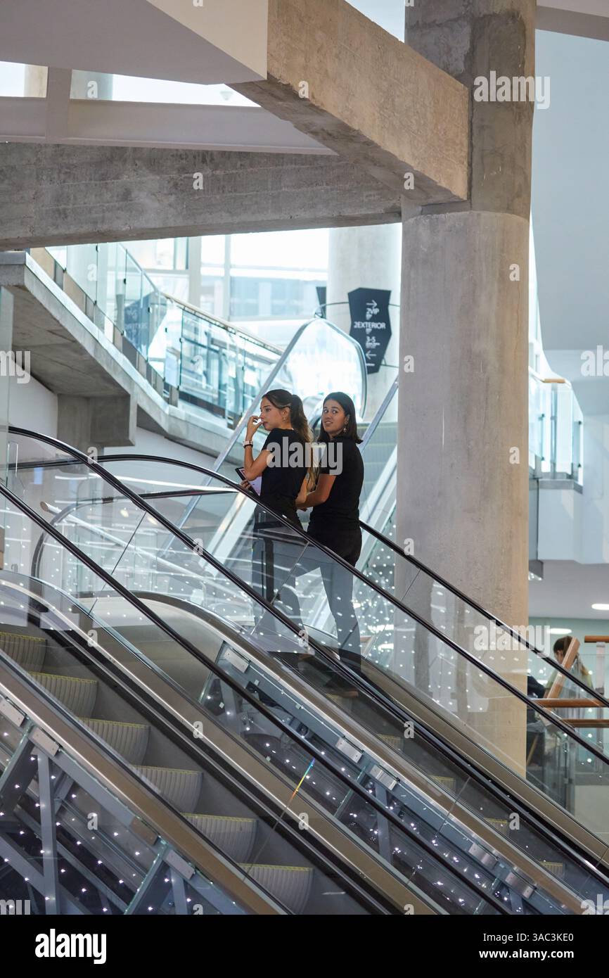 Zwei junge Leute, die Rolltreppen klettern, Palacio Euskalduna, Bilbao, Baskenland, Spanien Stockfoto