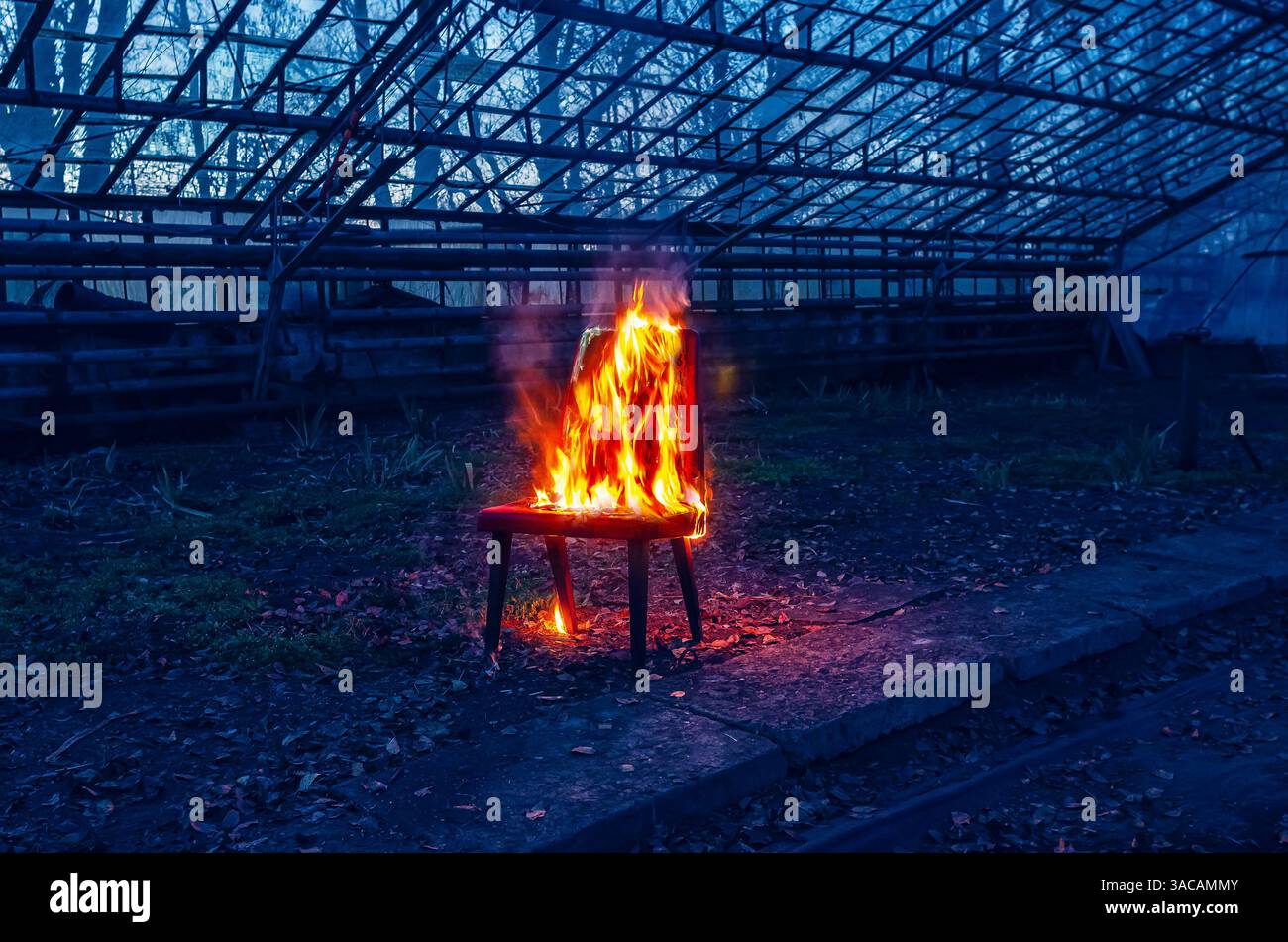 Holzstuhl ist auf Feuer. Verbrennung von Möbeln. Konzeptionelles Foto, Burnout Stockfoto
