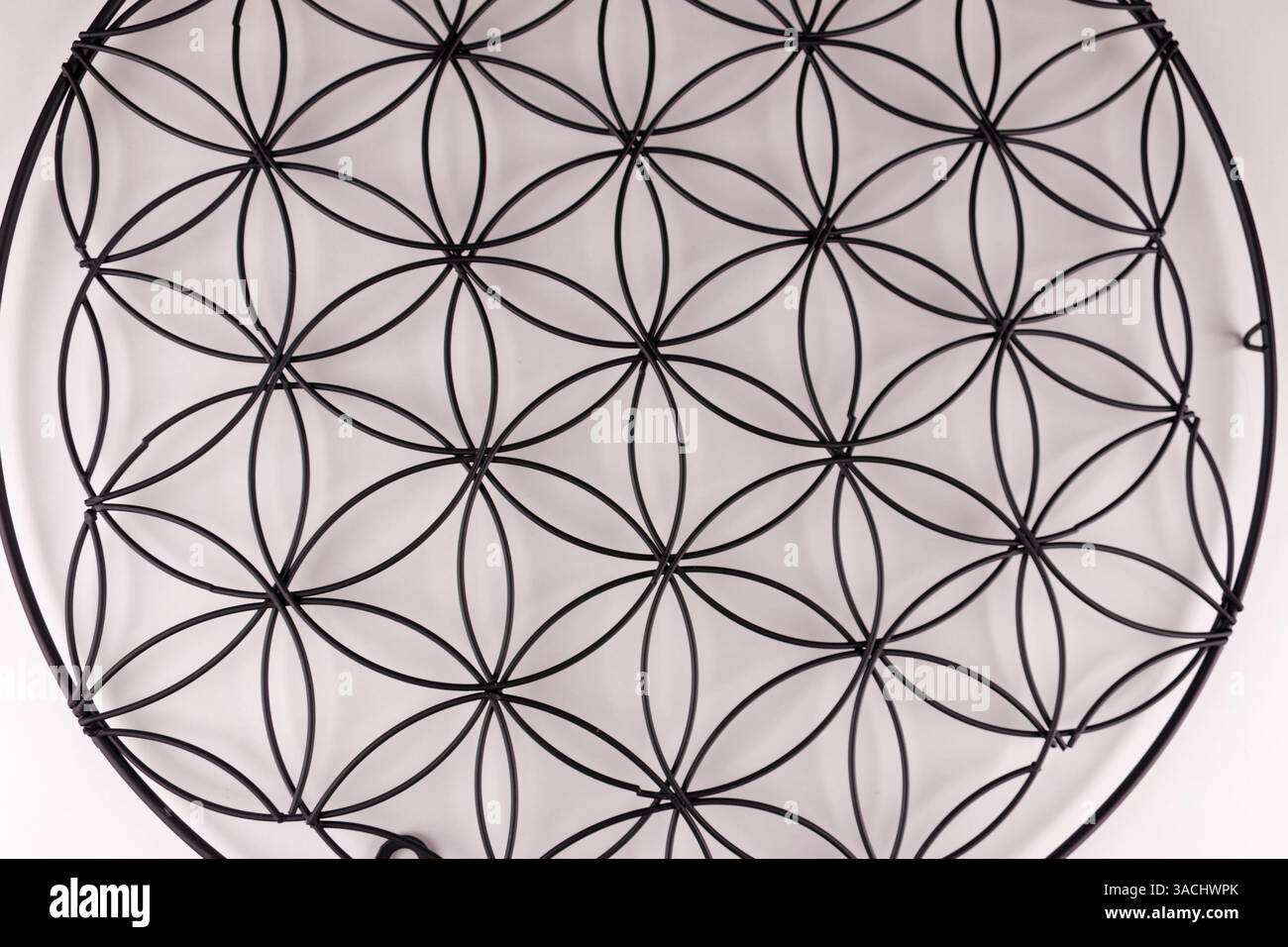 Schwarze Struktur auf weißem Hintergrund mit Blume des Lebens Symbol, heilige Geometrie oder Zen Symbol, Nahaufnahme Bild Stockfoto