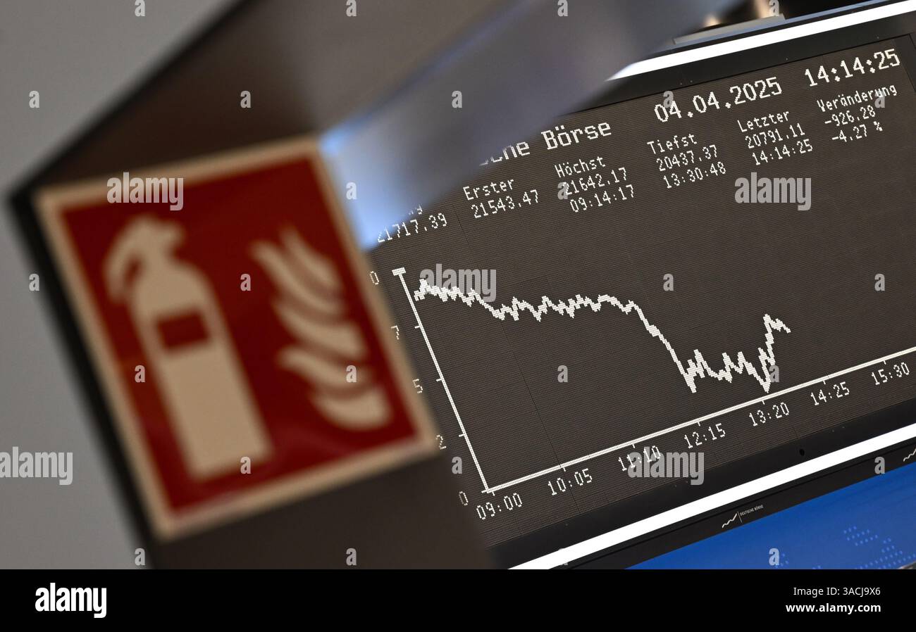 04. April 2025, Hessen, Frankfurt/Main: An einer Passage der Frankfurter Wertpapierbörse ist ein Feuerlöschschild zu sehen, während die Anzeigetafel mit der Dax-Kurve fallende Preise anzeigt. US-Präsident Trump hatte ein riesiges Zollpaket gegen Handelspartner auf der ganzen Welt veröffentlicht. Die Europäische Union und China haben bereits Gegenmaßnahmen angekündigt. Foto: Arne Dedert/dpa Stockfoto