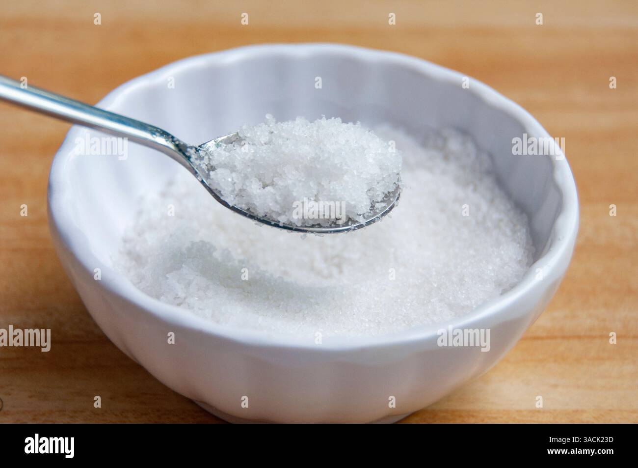 Seitenansicht eines mit grobem Salz gefüllten Löffels mit anpassbarem Platz für Text oder Ideen Stockfoto