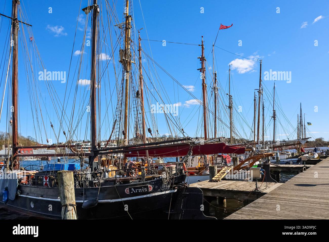 Viele traditionelle Segelschiffe legen an einem sonnigen Tag am Pier in Flensburg an Stockfoto