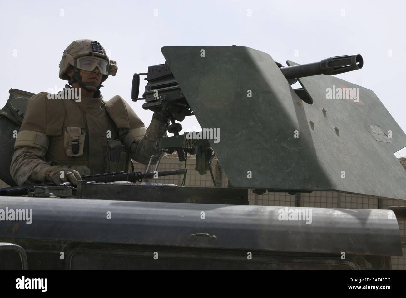 April 2005; Fallujah, Irak; PFC PAUL J. SPINELLI, MK-19-Schütze mit automatischem Granatwerfer mit 1. Bataillon, dem Personensicherheitszug des 6. Marineregiments, steht hinter dem Geschützturm seines Fahrzeugs und sucht den Horizont nach terroristischen Bedrohungen ab. Die 20-Mann-Einheit der Easton, Mass. Führt Missionen durch, wie zum Beispiel die Begleitung des Bataillonkommandeurs durch die Stadt, die Zusammenarbeit mit Infanterie-Kompanien, um Überfälle durchzuführen, und patrouilliert Falludschas Straßen auf der Suche nach Aufständischen. Obligatorische Angabe: Foto von CPL. Mike Escobar/DOD/ZUMA Press. (©) Copyright 2005 by US DOD Photo Stockfoto