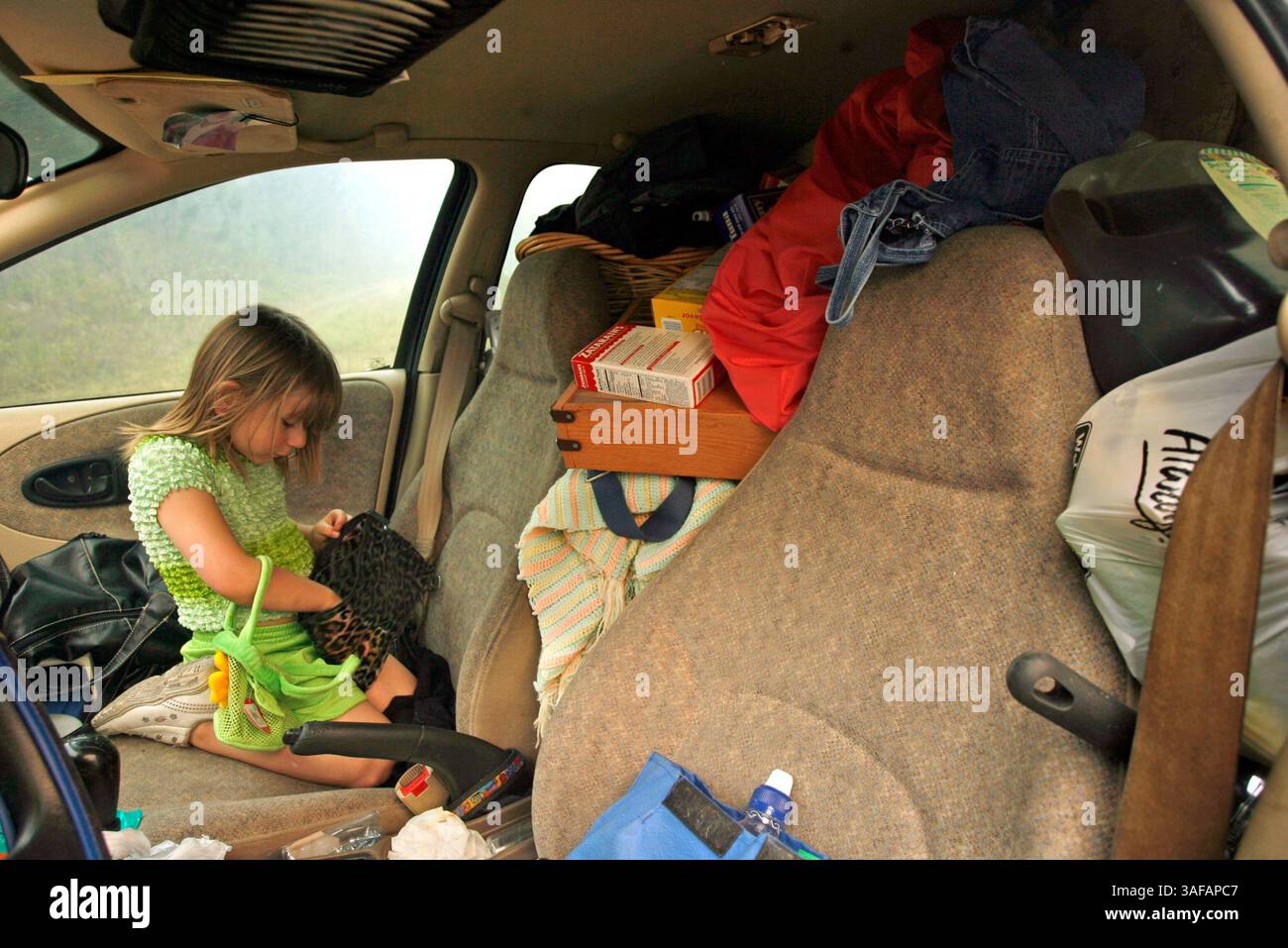 Foto 2 von 4.BILDUNTERSCHRIFT: (10.05.07, waldo, Fl.) Die 5-jährige Laci Eiseman wartet mit ihrem wertvollsten Besitz auf dem Rücksitz im Auto, während ihre Mutter Pamela Eiseman nach Verwandten und Nachbarn sucht, während brennende Brände Evakuierungen entlang der Kreisstraße 1471 im Landkreis Alachua am Donnerstag erzwangen (Credit Image: St Petersburg Times/ZUMAPRESS.com). Stockfoto