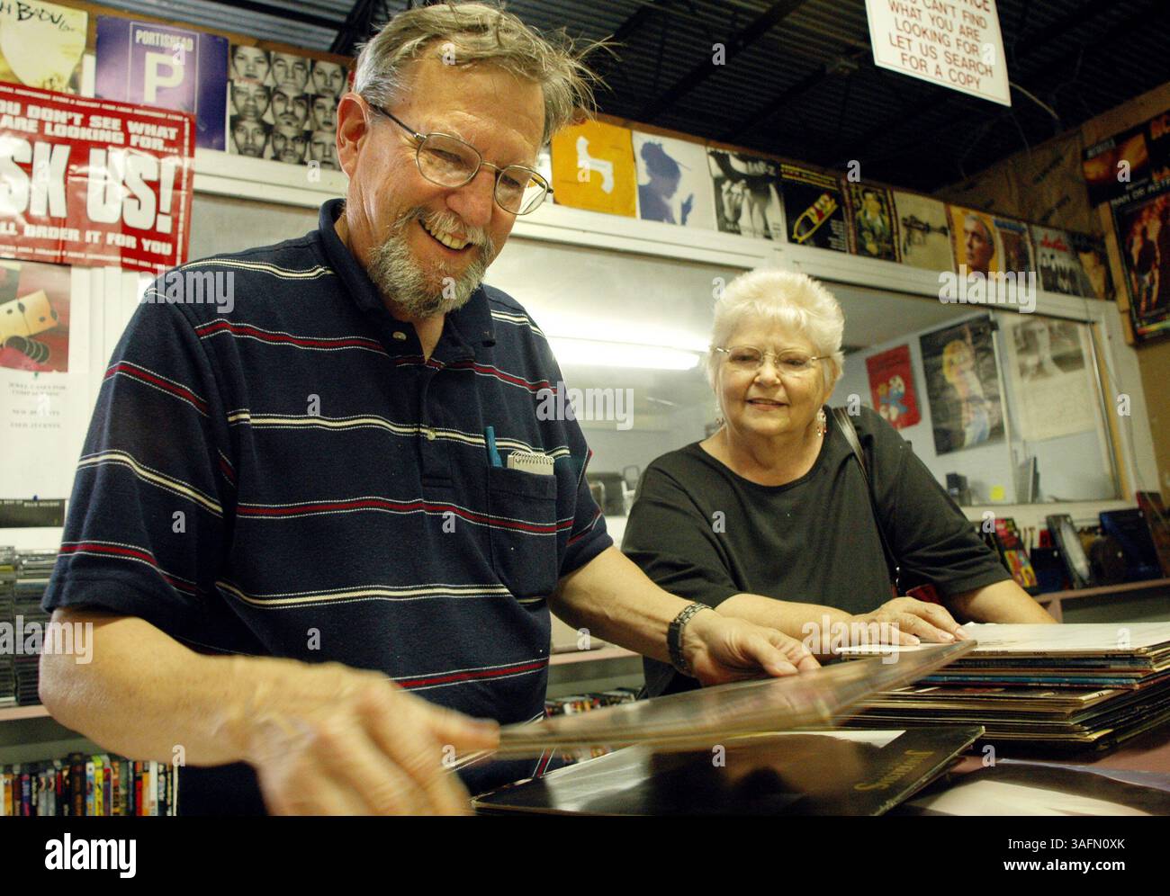 Bananas Music Besitzer Douglas Allen strömt durch alte Platten, die Sally Edwards am Donnerstag, 4. November 2004, zum Verkauf gebracht hat. Allen kaufte mehrere LPs, darunter auch von Tom Jones und Jose Feliciano und Edwards ging Away mit 0. Bananas Music mit Sitz in St. Petersburg kauft gebrauchte Platten, CDs und Kassetten und hat ein erfolgreiches Geschäft aufgebaut, das sie über das Internet weiterverkauft... Banana's Music in St. Petersburg ist eines der kleinen Unternehmen, das von Ketten und Discounters wie Wal-Mart, Best Buy und anderen verletzt wurde. Also beschloss der Eigentümer Doug Allen, sein Geschäft in drei Lagerhäuser zu verlegen und mehr als zu handeln Stockfoto