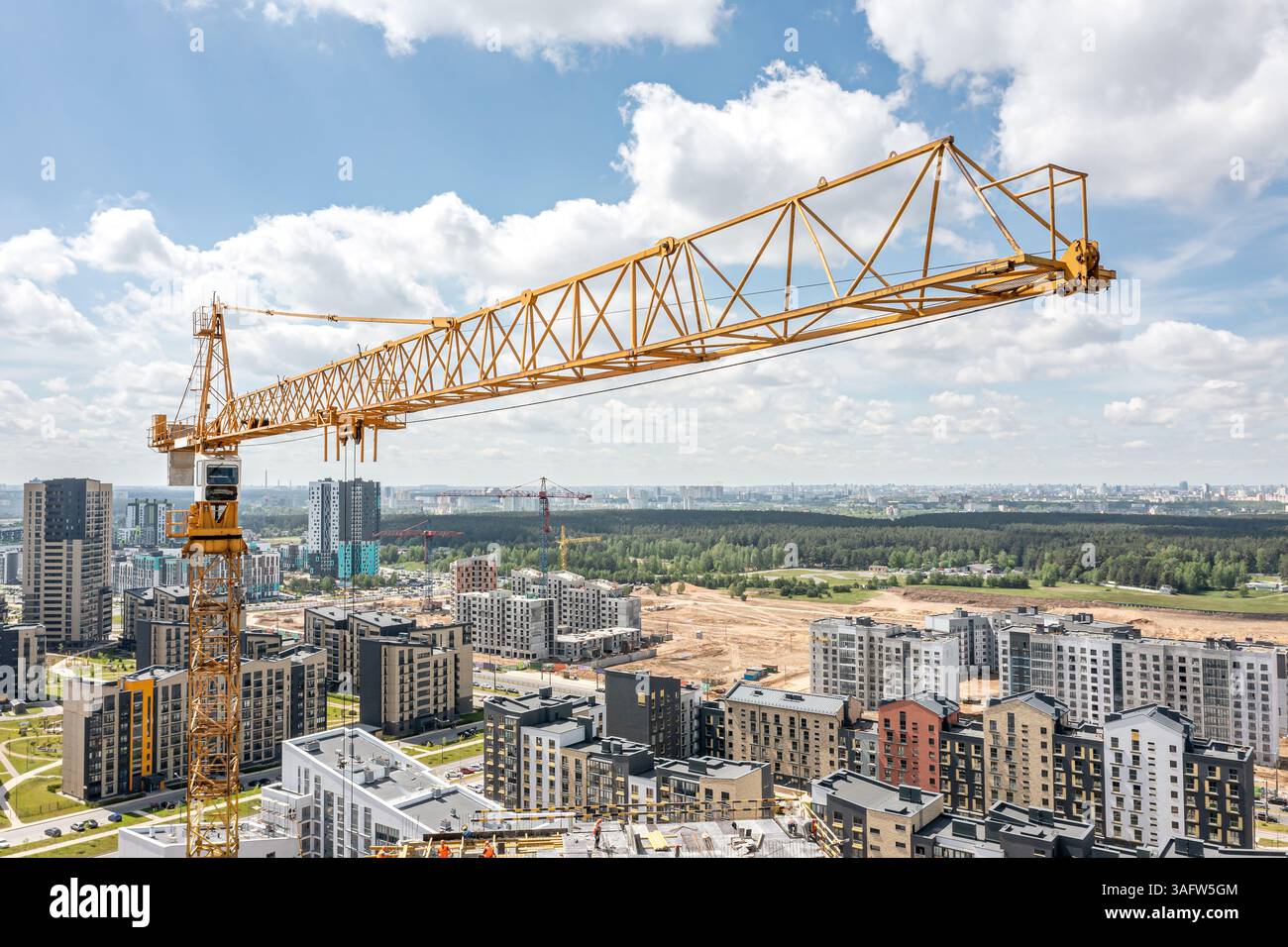 Gelber Turmkran auf der Baustelle. Weitwinkelansicht. Luftaufnahme von der fliegenden Drohne. Stockfoto