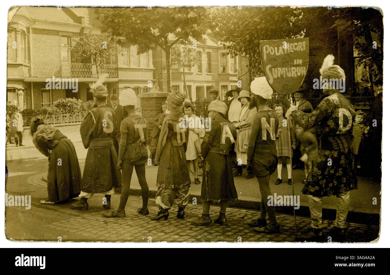 Ursprünglich aus den 1920er Jahren stammende Gruppe, die mit einem Banner für einen frühen Stummfilm mit Pola Negri in einem frühen Stummfilm namens Sumarun, der 1920 veröffentlicht wurde, wirbt. Vielleicht ist das eine Karnevalsprozession. Die Männer, die für diesen Stummfilm aus dem Jahr 1920 werben, erscheinen mit den aufgestickten Buchstaben für „Strand“ auf ihren Kostümen, die ein arabisches Thema haben. Sie sind schwarz in Turbanen und langen Tuniken. Das damalige Kino in The Strand bezieht sich wahrscheinlich auf Terrys Kino, das 1910 eröffnet wurde und Filme bis 1923 gezeigt hat, als es abgerissen wurde. The Strand, London, Großbritannien 1920-1922. Stockfoto