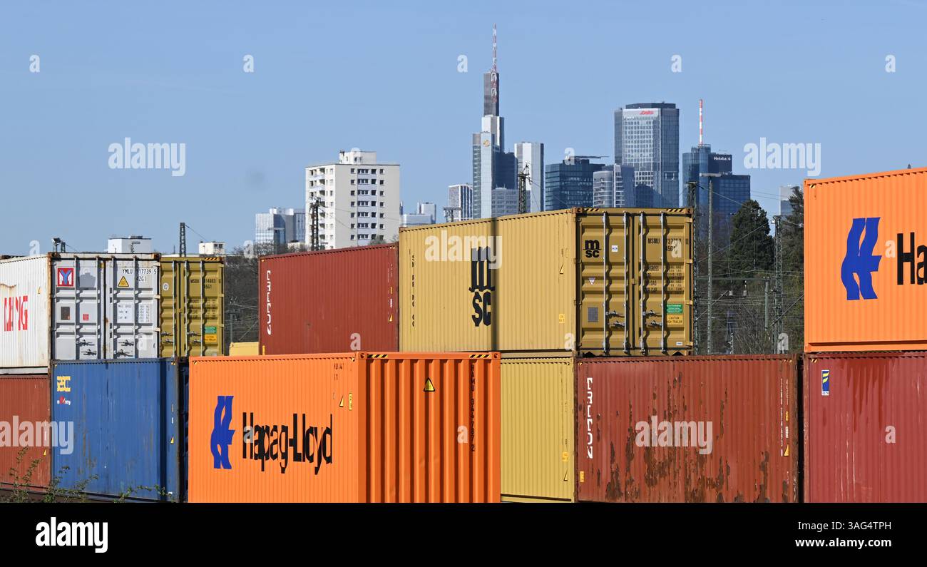 08. April 2025, Hessen, Frankfurt/Main: Im Osten der Bankenstadt werden Gütercontainer auf dem Gelände des Umschlagbahnhofs DB gestapelt. Die Wolkenkratzer der Bank-Skyline erheben sich hinter ihnen. US-Präsident Trumps aggressive US-Zollpolitik kann auch als Handelskrieg gegen den Rest der Welt angesehen werden. Nach drei Tagen des Handels mit dem Rot startete der DAX am Dienstag wieder höher. Foto: Arne Dedert/dpa Stockfoto