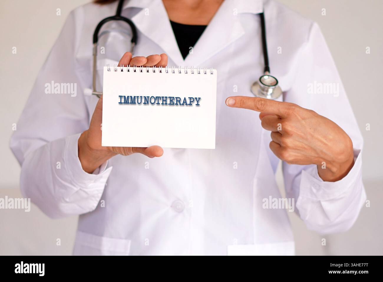 Immuntherapie. Medizinische Konzepte. Die Ärztin zeigt auf das Wort, das in einem Notizbuch steht. Stockfoto