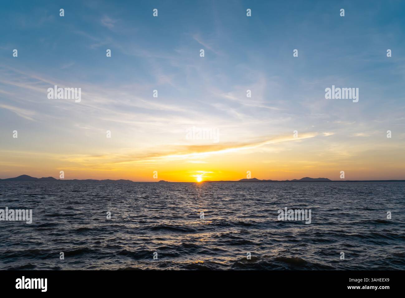 Wunderschöner Morgen- oder Abendhimmel in Blau und Orange mit bewölktem Himmel, während Sonnenuntergänge oder Sonnenaufgänge am Meer aufgenommen wurden, als natürliche Hintergrundtextur verwendet Stockfoto