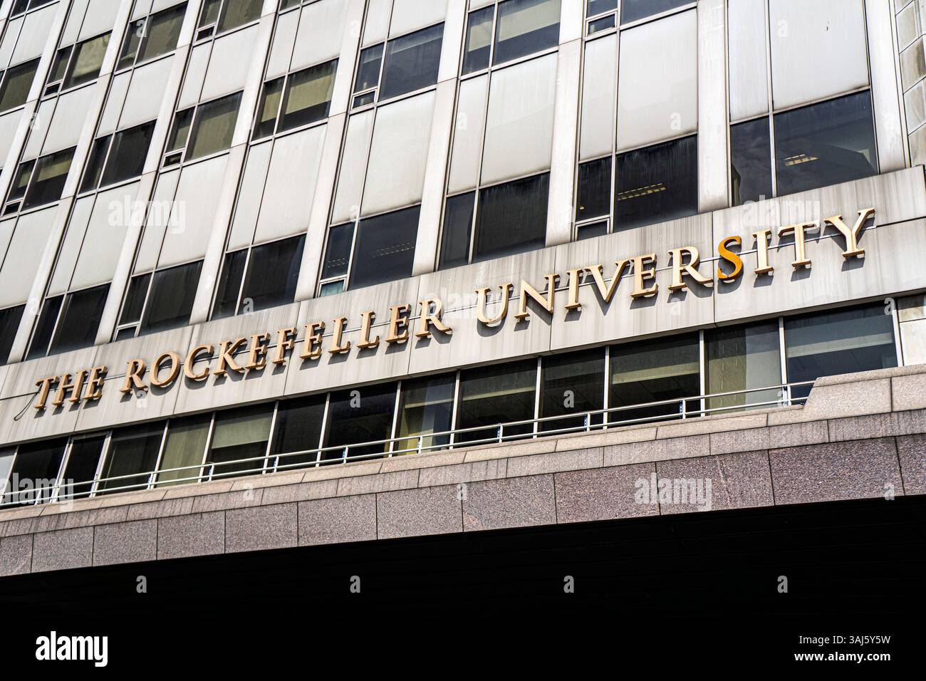 Die Rockefeller University, eine private biomedizinische Forschungsuniversität, die nur für Absolventen bestimmt ist, zeigt den Namen der Universität an der Außenfassade des Gebäudes in New York City Stockfoto