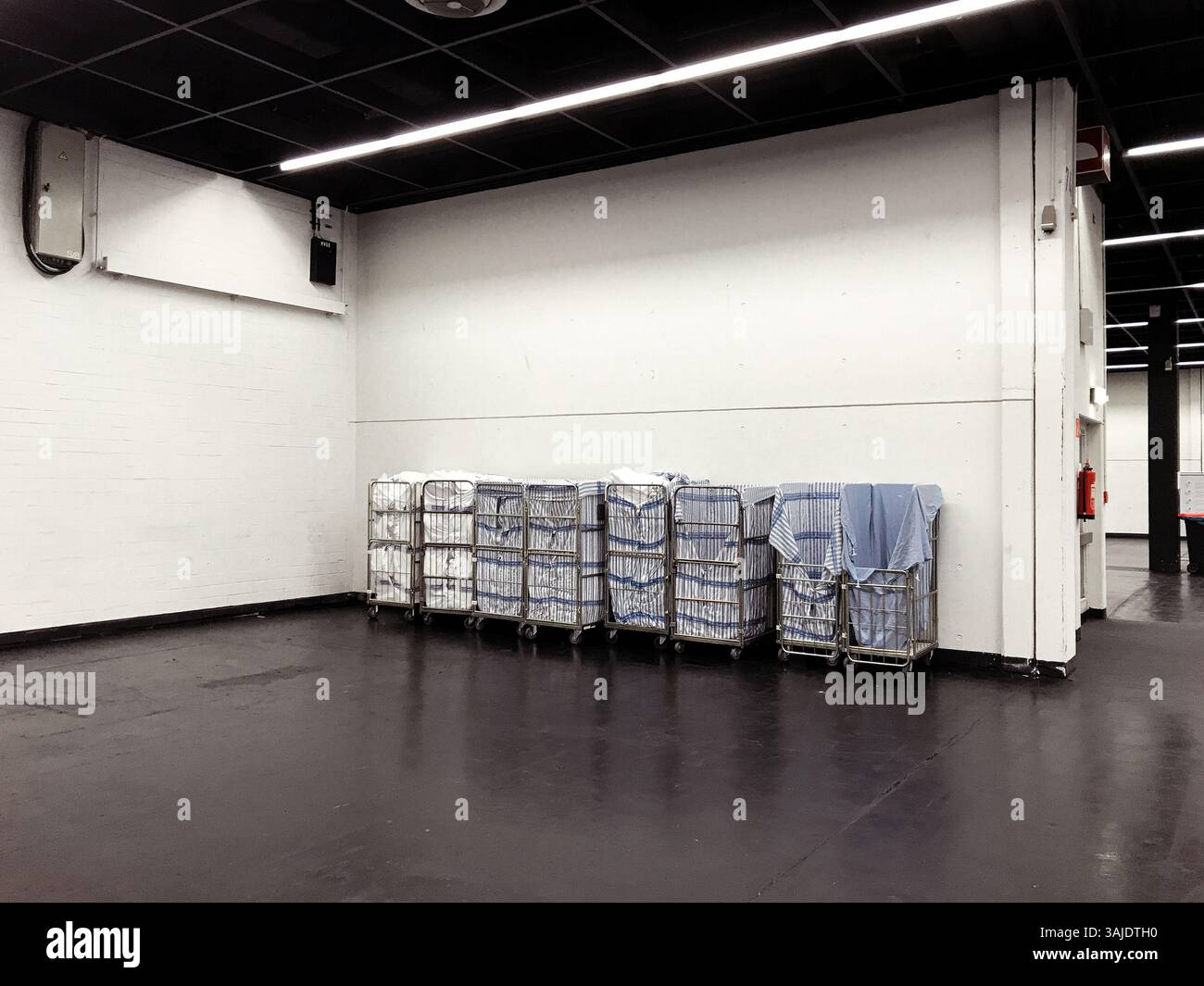 Köln, Deutschland - 18. März 2022 der Raum ist leer und hat viele weiße Behälter und ein paar blaue Behälter gestapelt. Die Behälter sind in verschiedenen Teilen Stockfoto