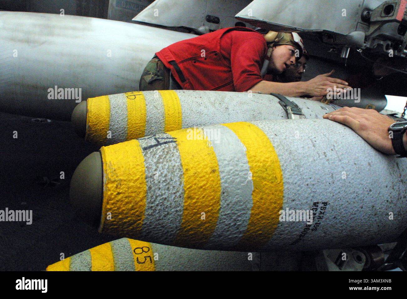 27. Januar 2003 - USA - KRT WORLD NEWS STAND ALONE FOTO SCHLEPPEND: MILITÄR-KRT-FOTO VON PAULINE LUBENS/SAN JOSE MERCURY NEWS (Januar 31) Luftfahrtanordnung Luftmann Erik Coleman, 20, aus Midland, Texas, schaut sich Joint Direct Attack Munitions (JDAMs) an, bevor er sie auf Flugzeuge der USS Constellation, die derzeit im Persischen Golf am Dienstag, 28. Januar 2003 eingesetzt wird, verladen. JDAMs wandeln ungelenkte Bomben in präzise gesteuerte ''intelligente'' Bomben um. (lde) 2003 (Bild: © Pauline Lubens/mct/ZUMAPRESS.com) Stockfoto
