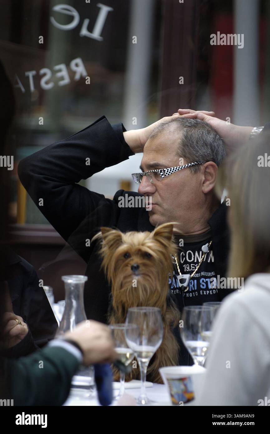 8. April 2006 – USA – mit seinem besten Freund im Schoß genießt ein unbekannter Mann ein gemütliches Mittagessen im Restaurant Le Layon in der Rue Merciere im französischen Presqu'Ile-Viertel von Lyon. (Bill Hogan/Chicago Tribune/MCT) (Kreditbild: © Bill Hogan/mct/ZUMAPRESS.com) Stockfoto