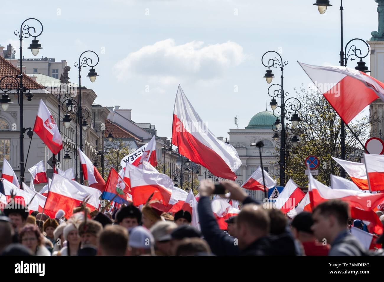 Die Anhänger schwenken polnische Nationalflaggen und schreien während der Kundgebung Slogans. In Warschau fand ein marsch zum 1000. Jahrestag des polnischen Königreichs und zum 500. Jahrestag der preußischen Hommage statt. Tausende von Teilnehmern, viele mit weißen und roten Fahnen und Bannern, gingen durch die Straßen und skandierten Slogans wie „Republik“ und „Don't Fear Tusk“. Gegen Mittag nahm Jaroslaw Kaczynski an der Veranstaltung Teil, wie zuvor angekündigt. Um 14:00 Uhr sprach Karol Nawrocki, der Präsidentschaftskandidat, der von der Partei Recht und Gerechtigkeit (PiS) unterstützt wurde, an die Menge am Castle Square, die Gehör hatte Stockfoto
