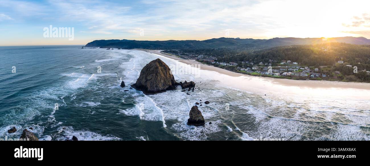 Blick aus der Vogelperspektive auf den wunderschönen Cannon Beach mit dem berühmten Haystack Rock und dem ruhigen Pazifik bei Sonnenaufgang, Cannon Beach, Oregon, USA. Stockfoto