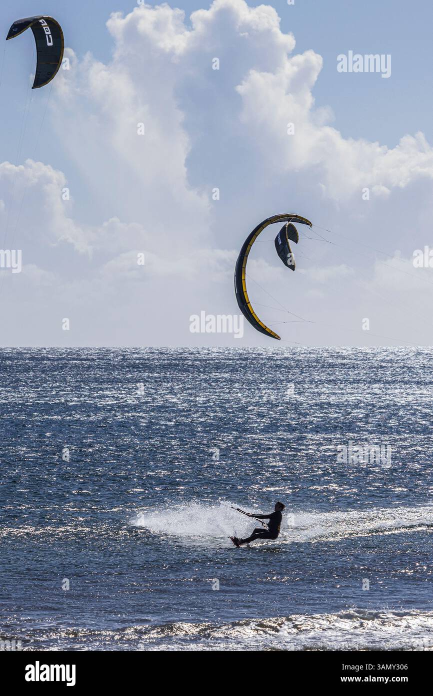 Windsurfen und Kitesurfen an einem hellen windigen Tag in El Medano an der Ostküste von Teneriffa, Kanarischen Inseln, Spanien Stockfoto