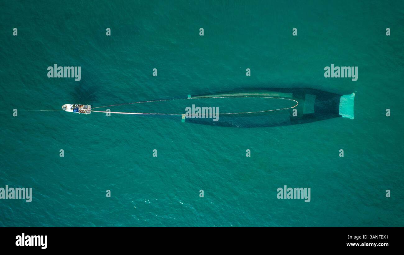 Aus der Vogelperspektive eines Motorbootes, das mit einem Netz in El Golfo, Mittelmeer, Girona, Spanien angeln kann. Stockfoto