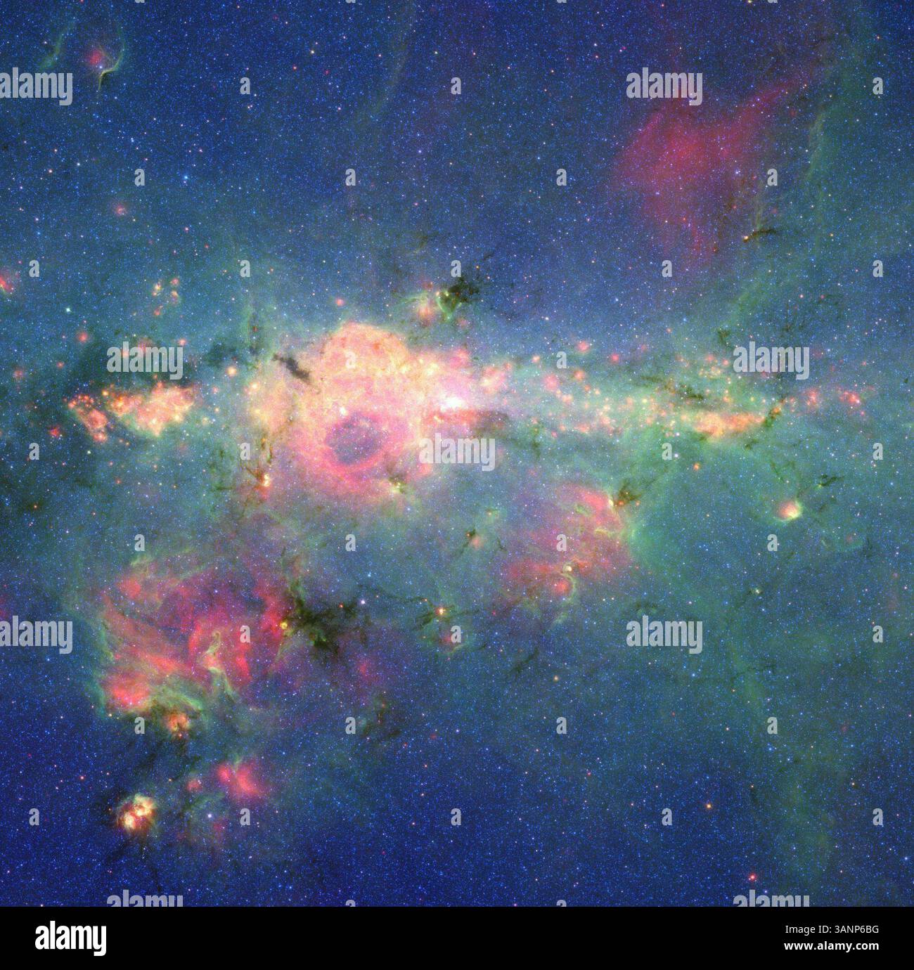 12. April 2011 - Milky Way Galaxy - die Sterne versammeln sich in der „Downtown“ Milky Way. Die Region um das Zentrum unserer Milchstraße leuchtet bunt in dieser neuen Version eines Bildes, das vom Spitzer-Weltraumteleskop der NASA aufgenommen wurde. Die unzähligen Sterne, die das Zentrum unserer Galaxie bevölkern, erzeugen den blauen Dunst, der sich zum Zentrum hin aufhellt. Die grünen Merkmale stammen von kohlenstoffreichen Staubmolekülen, den sogenannten polyzyklischen aromatischen Kohlenwasserstoffen, die vom umgebenden Sternenlicht beleuchtet werden, während sie um den Kern der Galaxie wirbeln. Die gelb-roten Flecken sind das thermische Leuchten von warmem Staub. Das polyzyklische aromatische HY Stockfoto