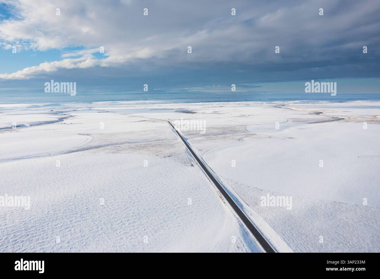 Luftaufnahme der schneebedeckten Straße, die sich durch Wolken schlängelt, in einer ruhigen Landschaft, Benton County, USA. Stockfoto