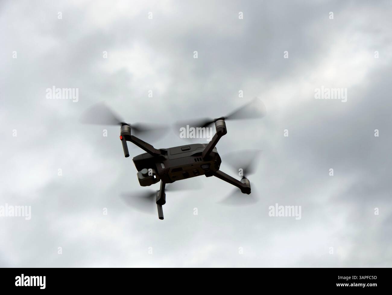 Silhouette einer Drohne im Flug im Hinterlicht gegen den Himmel, Schweiz Stockfoto
