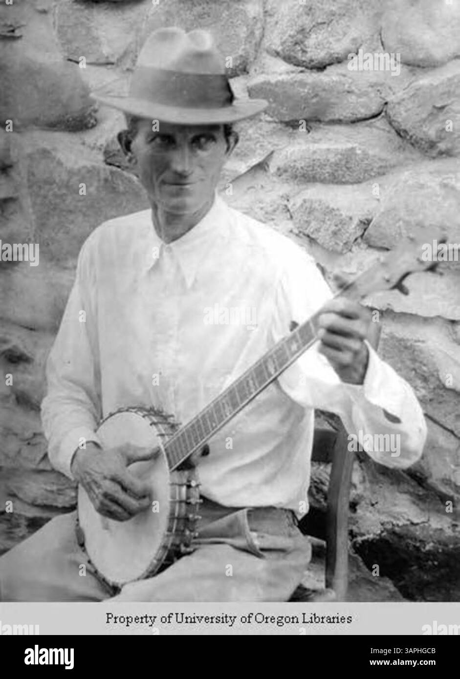 Dieses Foto aus der Doris Ulmann-Sammlung zeigt einen Mann, der während des Old Timers Day ein Banjo spielt. Das Bild zeigt amerikanische Volkstraditionen und gesellschaftliche Zusammenkünfte im frühen 20. Jahrhundert. Stockfoto