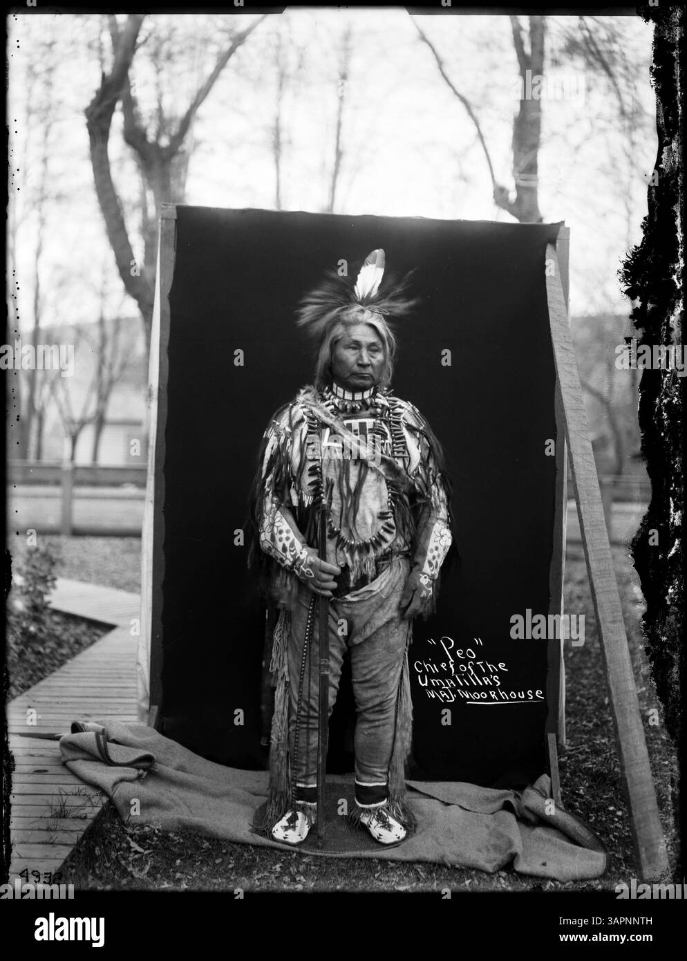 Dieses Porträt zeigt Häuptling PEO, einen Stammesmann der Umatilla, gekleidet in verschiedene Insignien. Das Foto ist Teil der Lee Moorhouse Sammlung, die die Führung und Kleidung der Ureinwohner dokumentiert. Stockfoto
