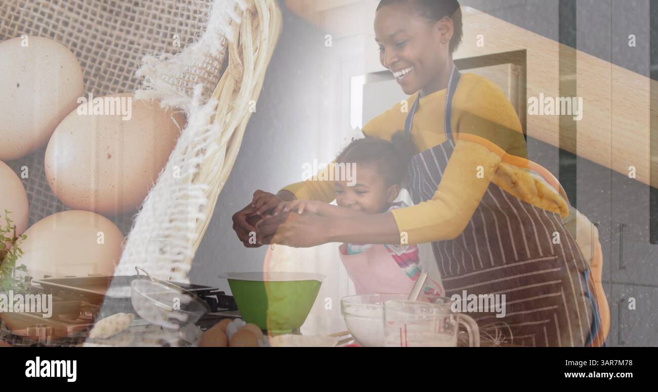 Bild einer glücklichen afroamerikanischen Mutter und Tochter, die über Eiern und Korb kochen Stockfoto