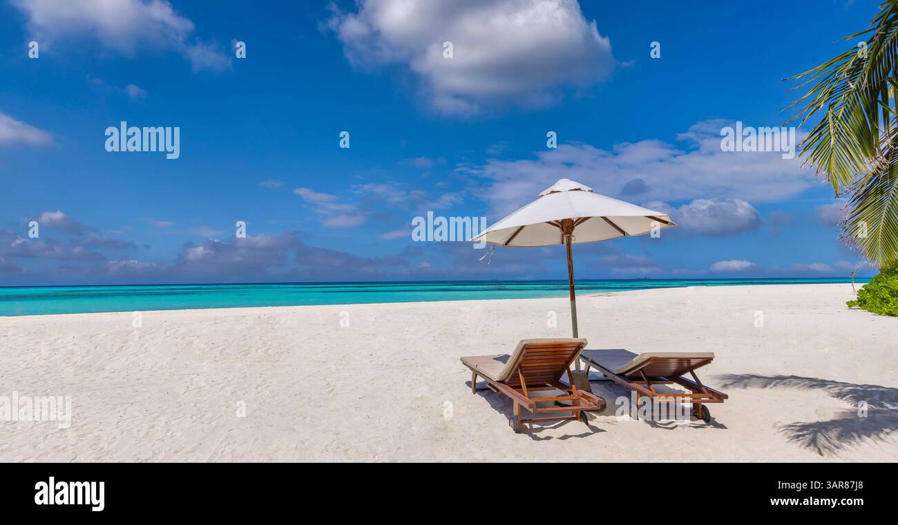 Liegestühle Sonnenschirm romantischer Flitterwochenstrand, romantisch für Sommerurlaub, entspannendes Meer mit atemberaubender Aussicht, sonniger Himmel und tropischer Zufluchtsort Stockfoto