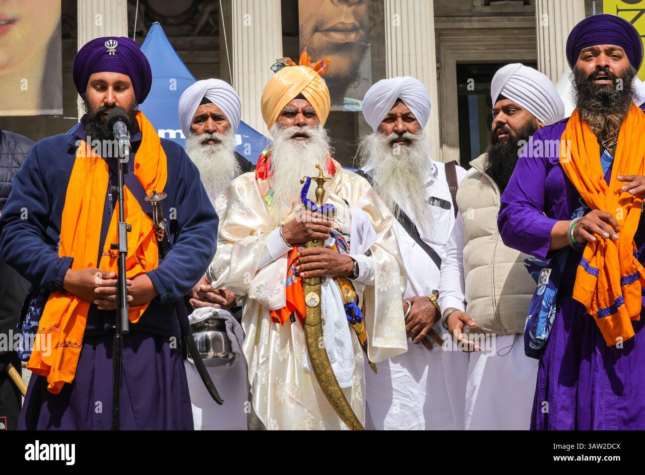 London, Großbritannien. April 2025. Eine Gruppe in traditioneller Sikh-Kleidung und traditionellen Accessoires wie dem Kirpan (Schwert oder Dolch) und kara (Stahlarmband) eröffnen das Festival mit einer Parade um den Platz und einem kurzen Gebet auf den Stufen vor der Nationalgalerie. Das Vaisakhi Festival, eine Feier der Sikh-Kultur und des Kulturerbes, wird mit Aufführungen, Musik, Essen, Gemeinschaftsaktivitäten und Freude für alle am Trafalgar Square gefeiert. Vaisakhi ist eines der wichtigsten Termine im Sikh-Kalender und wird weltweit gefeiert. Quelle: Imageplotter/Alamy Live News Stockfoto