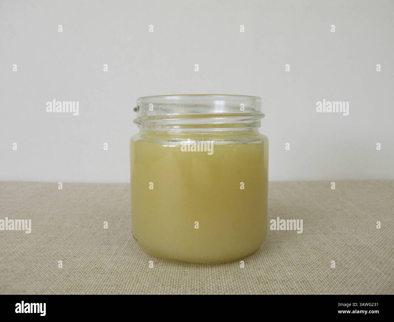 Ein Glas Honig mit hellgelbem Limettenblütenhonig Stockfoto