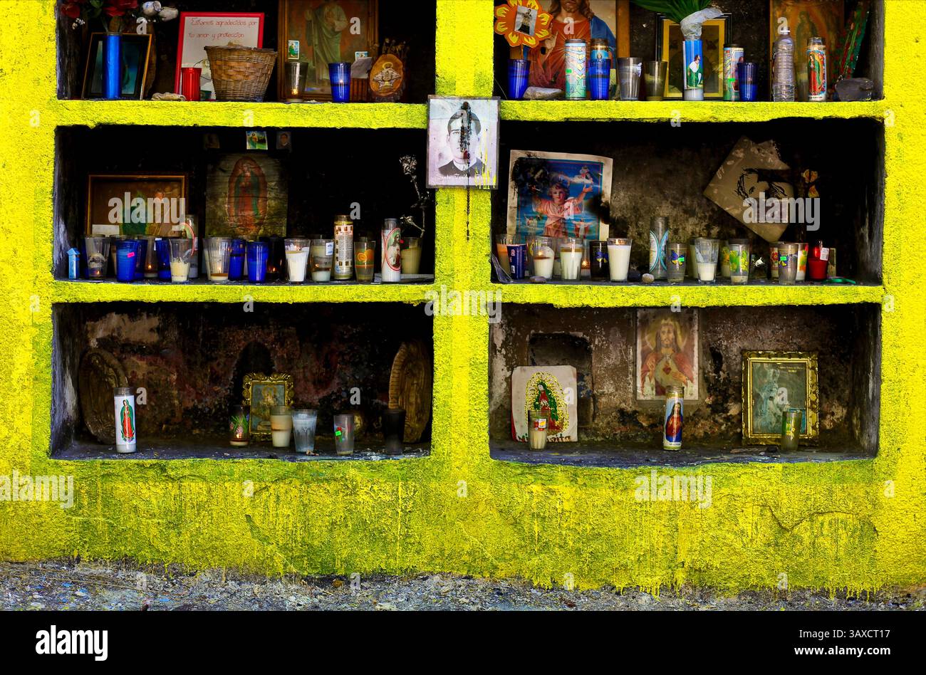 Eine mexikanische Capilla gefüllt mit Gebetskerzen, Rosenkranzen, Bildern von Lieben und anderen religiösen Artefakten. Stockfoto