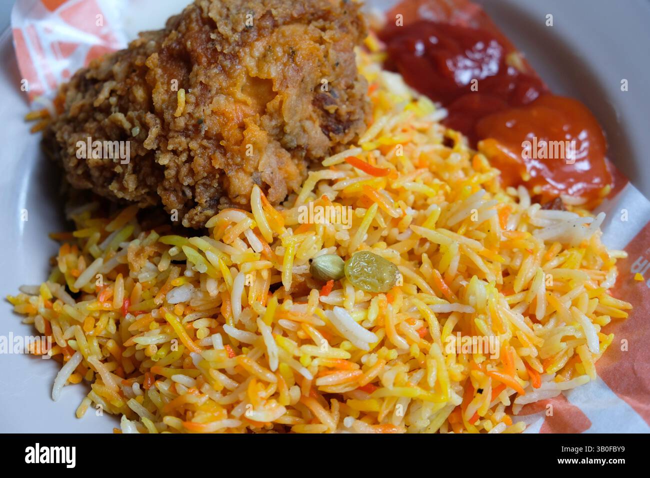 Nahaufnahme von Kebuli-Reis und knusprigem gebratenem Huhn Stockfoto