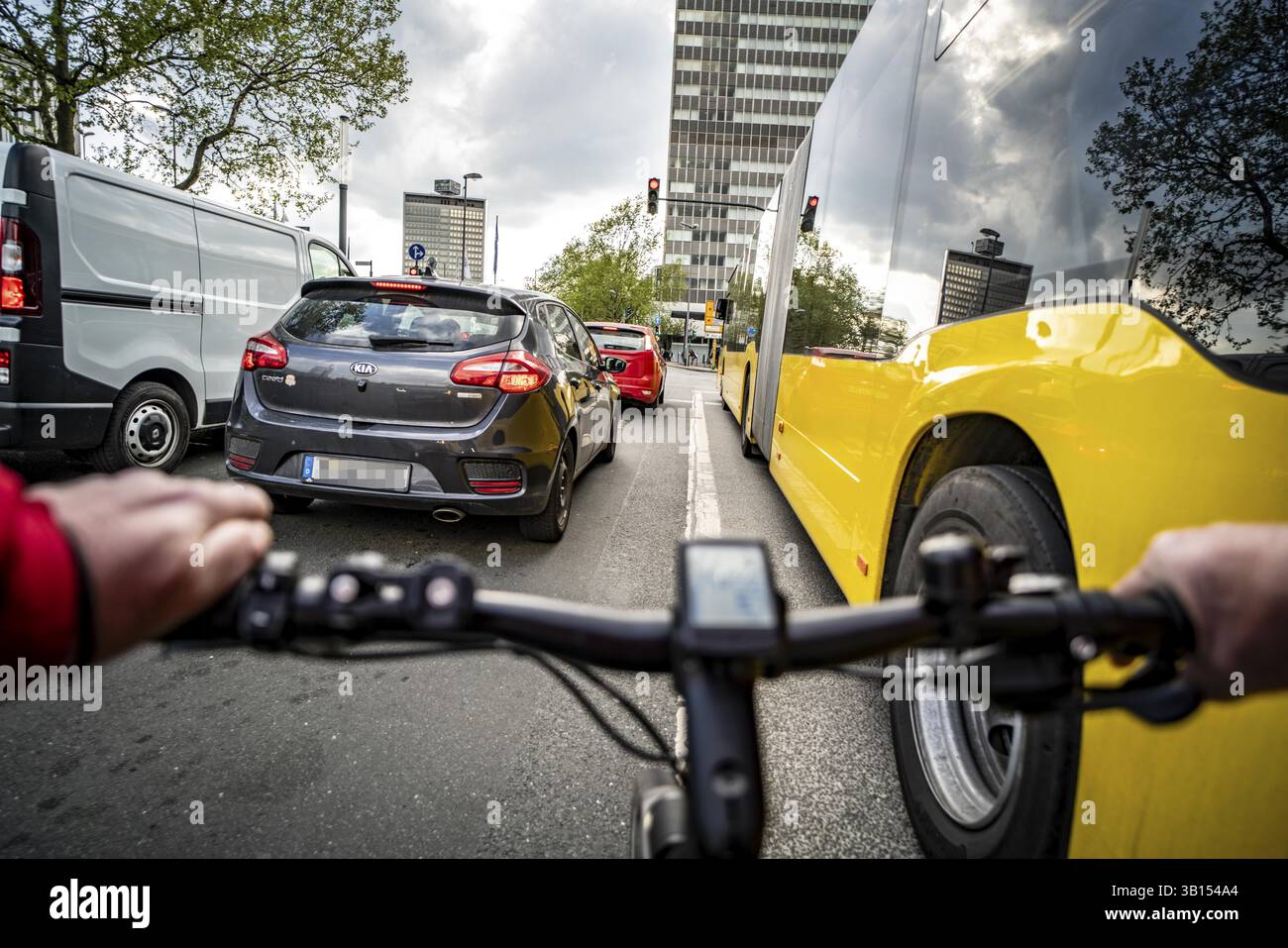 Radfahren in der Stadt, Stadtstraße, kein Radweg, Bushaltestelle, zweispuriger Verkehr in beide Richtungen, Radfahrerperspektive, Essen, Nordrhein-Westpha Stockfoto