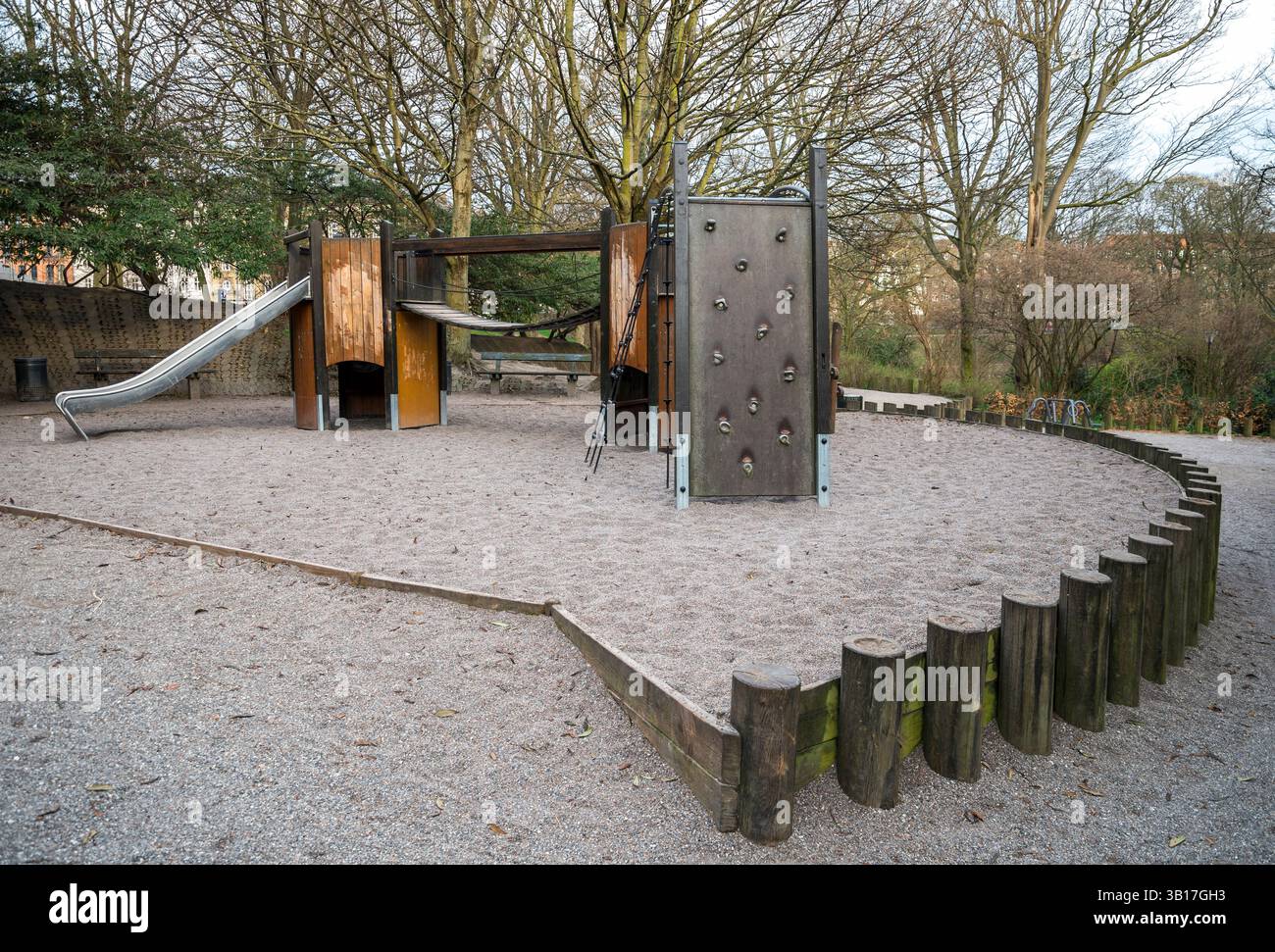 Holzspielgeräte in einem von Bäumen und umzäunten Park, Kopenhagen, Dänemark, 16. April 2018 Stockfoto