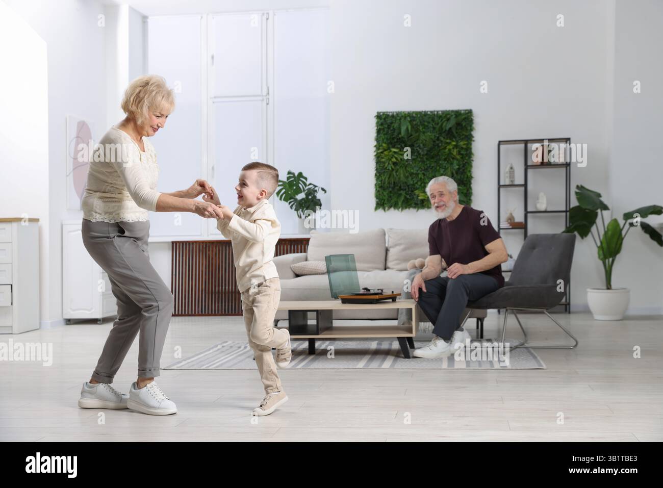 Die Großeltern und ihr Enkel haben zu Hause Spaß Stockfoto