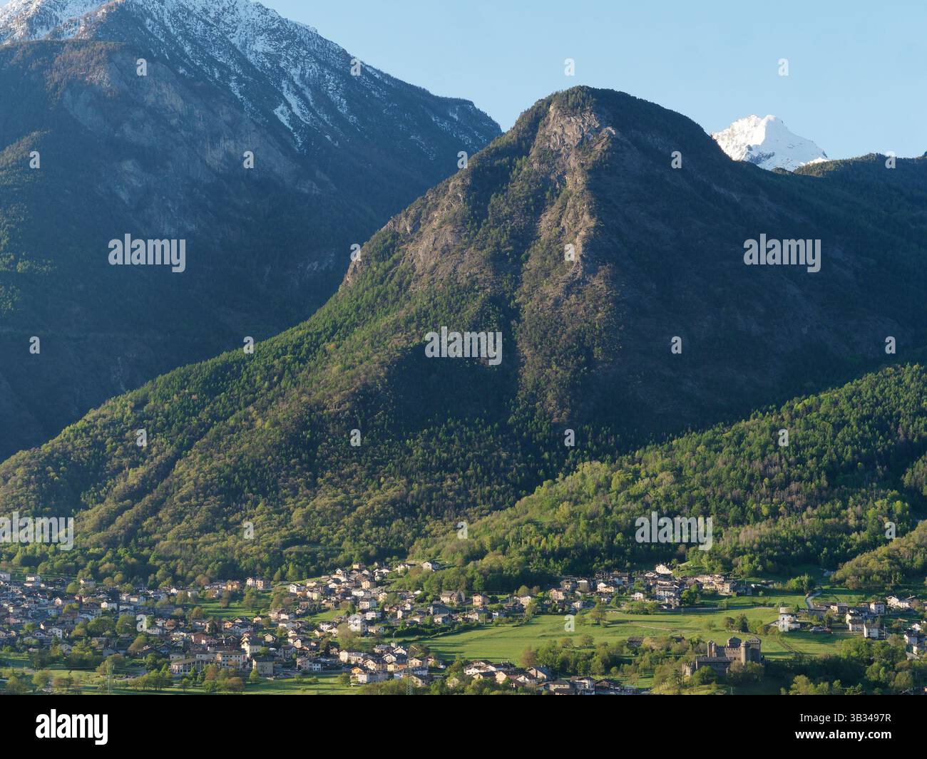 Blick über die Stadt Fenis und ihre Burg unter schneebedeckten Bergen im Aostatal, Italien, 24. April 2025 Stockfoto