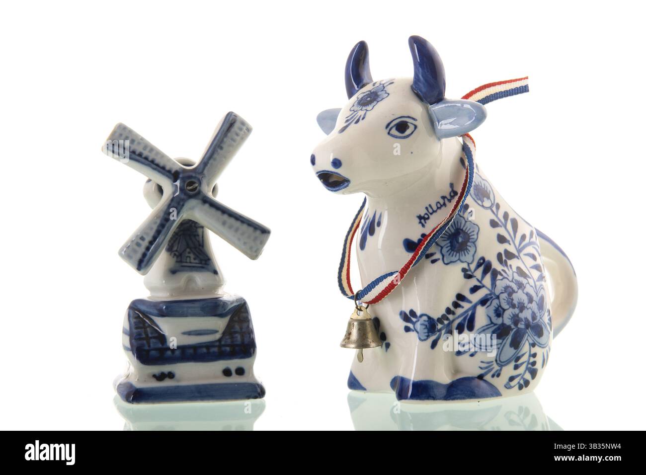 Souvenirs niederländische Kuh und Windmühle isoliert auf weißem Hintergrund Stockfoto