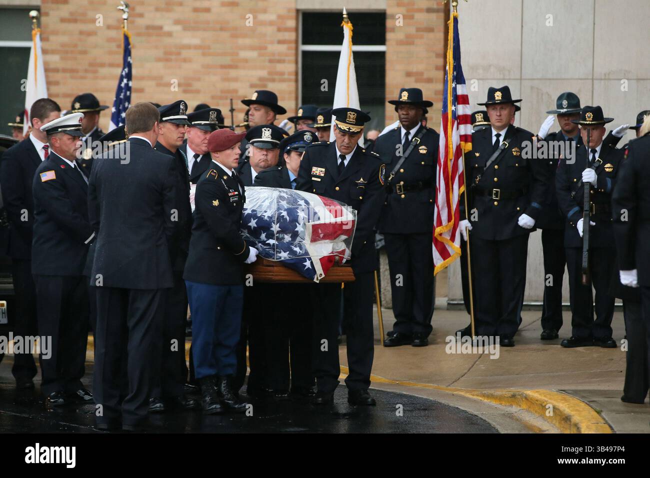 7. September 2015 - Antioch, IL, USA - der Sarg des getöteten Fox Lake Police Lt. Charles Joseph Gliniewicz kommt am Montag, 7. September 2015 in Antioch, Illinois, an der Antioch Community High School an. Der Mann in der kastanienbraunen Baskenmütze ist Lt. Gliniewicz Sohn. Tausende Polizisten und Bewohner werden heute Morgen an seiner Beerdigung in der Schule teilnehmen. (Bild: © Stacey Wescott/TNS via ZUMA Wire) Stockfoto