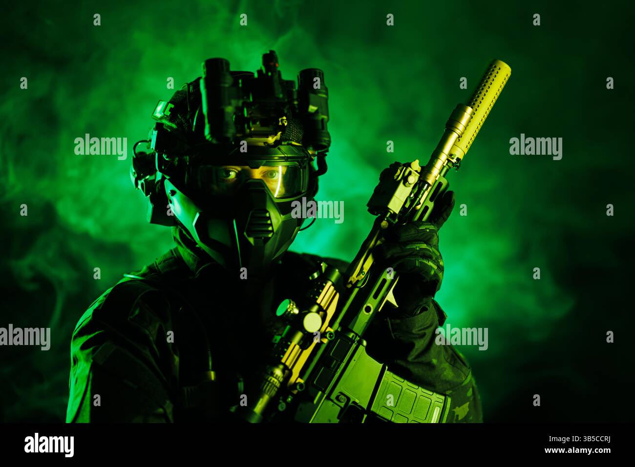 Ein taktischer Agent, der Spezialausrüstung, Nachtsichtbrille und eine fortschrittliche Schusswaffe trägt, beleuchtet durch dramatisches grünes Licht. Die Scen Stockfoto