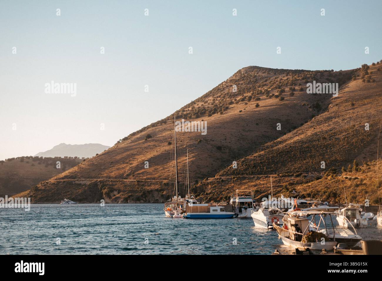 Porto Palermo Bucht mit Booten und Hügel, Albanien Stockfoto